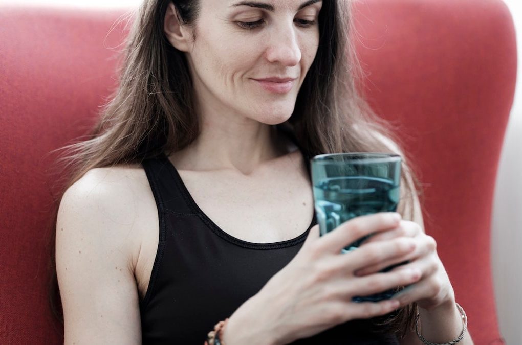 beautiful girl holding a glass of water