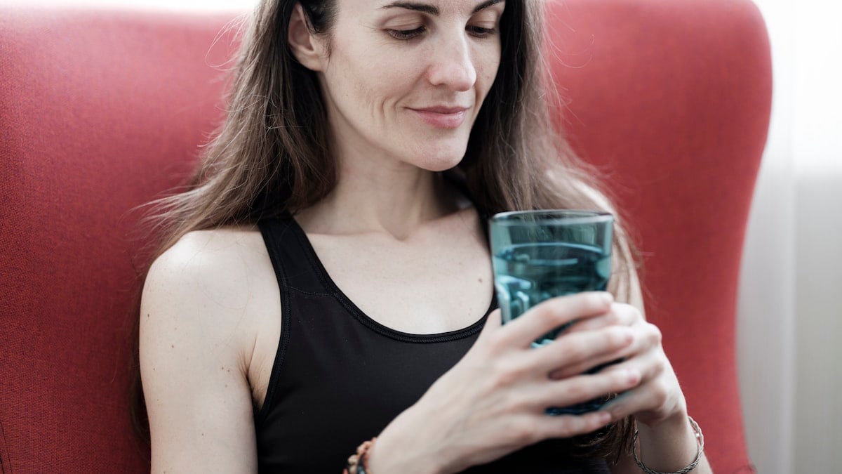 beautiful girl holding a glass of water